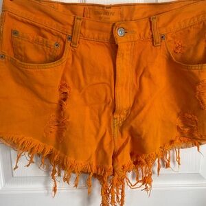 Vintage distressed orange Levi’s jean shorts